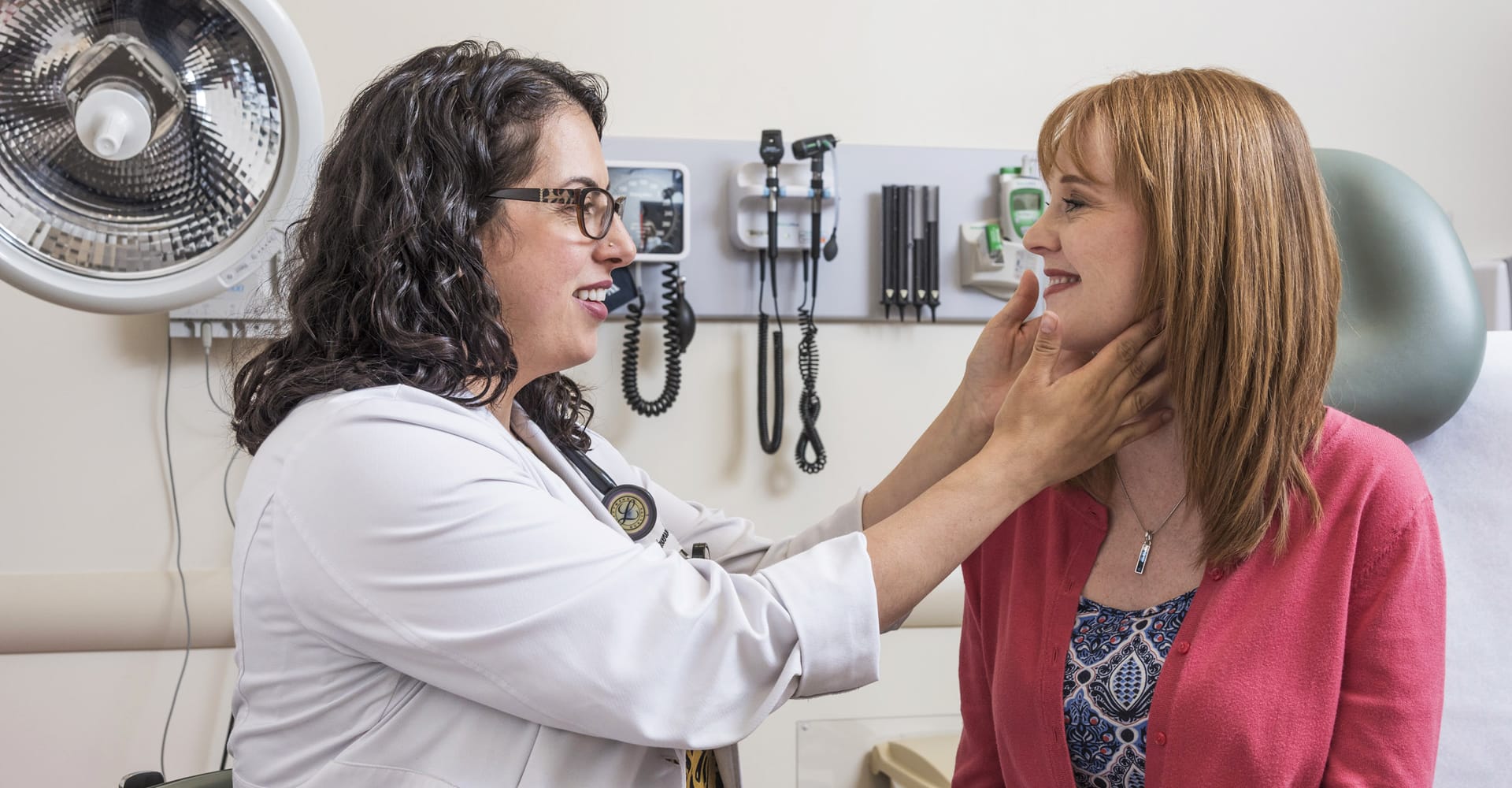 A health care provider and patient in an exam setting