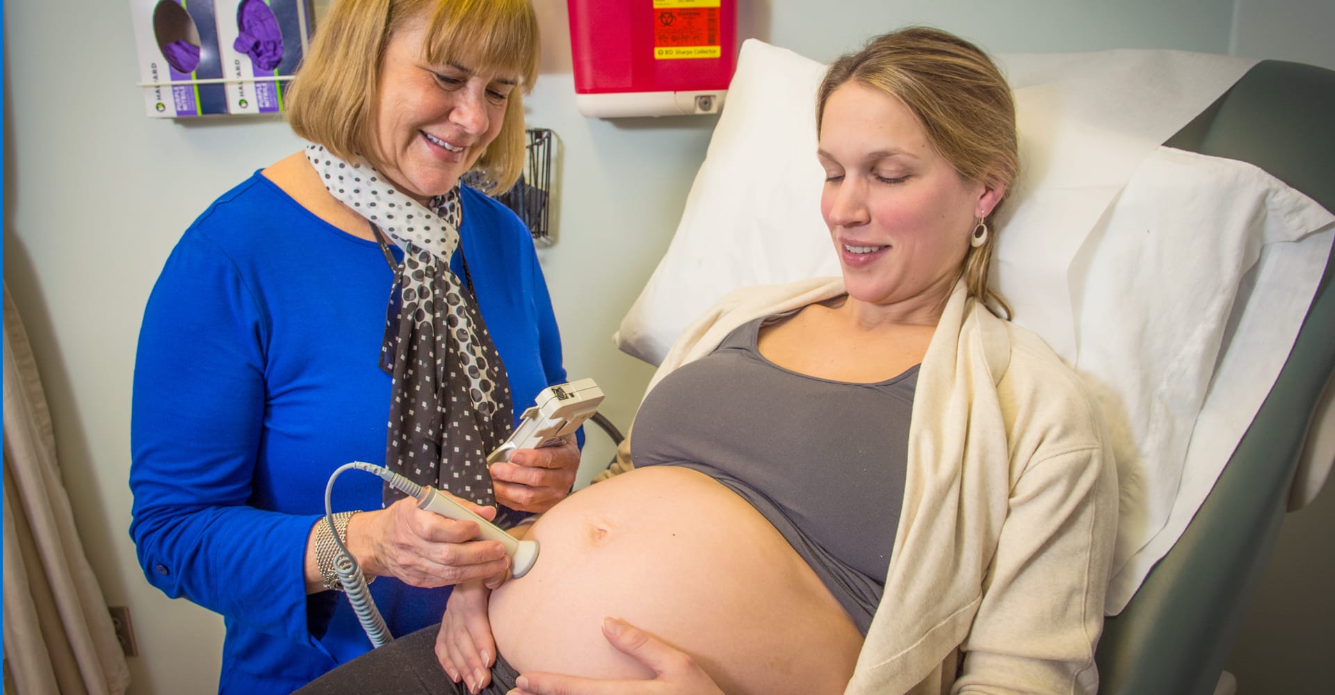 A health care provider performing an ultrasound for a pregnant patient