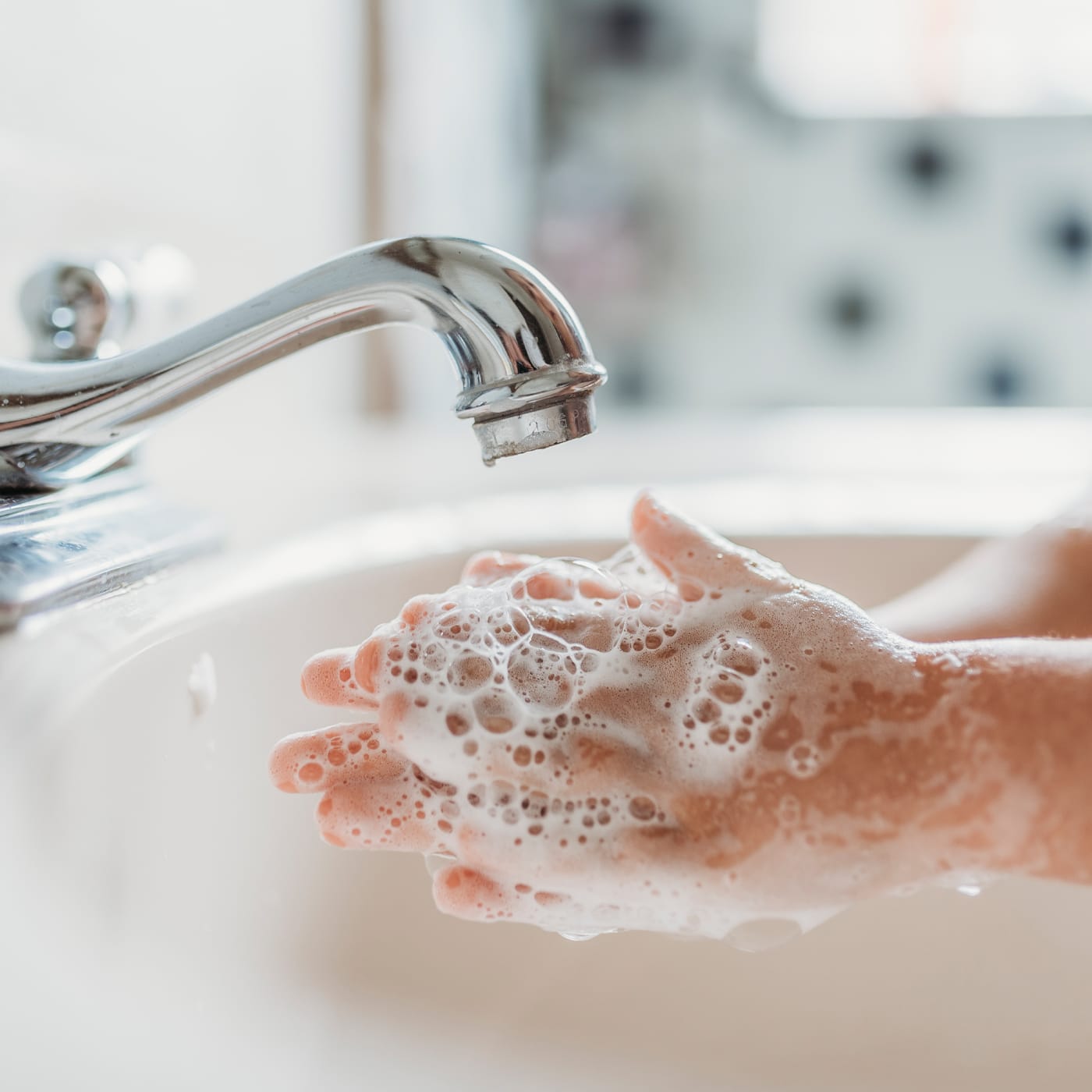 A close-up oof someone washing their hands