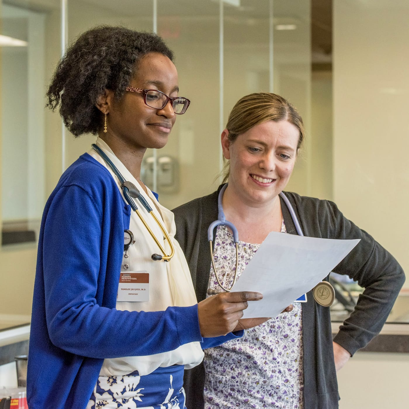 Two health care providers looking over medical documents together