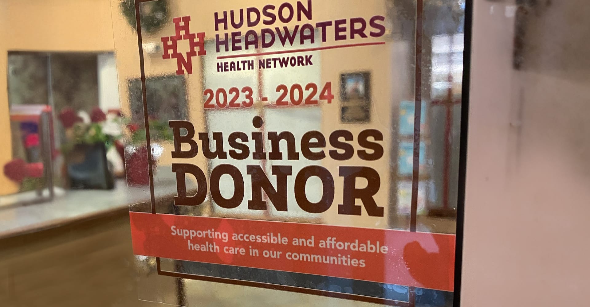 A window decal showing recognition for being a member of the 2023-2024 Business Donor Program