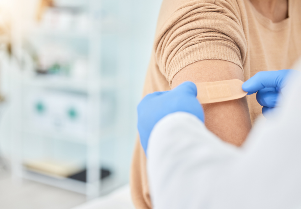 medical professional putting a bandage on a patient