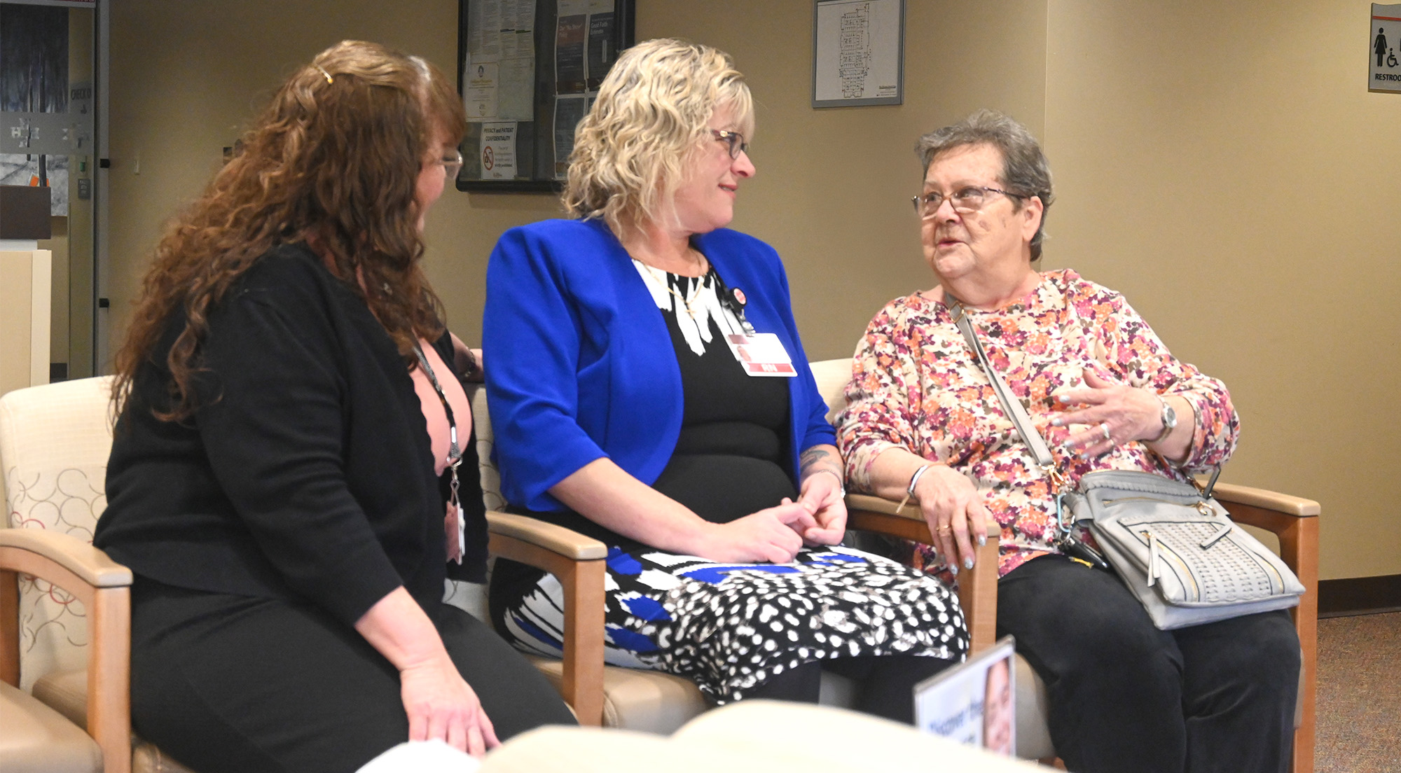 Two care managers talking with a patient