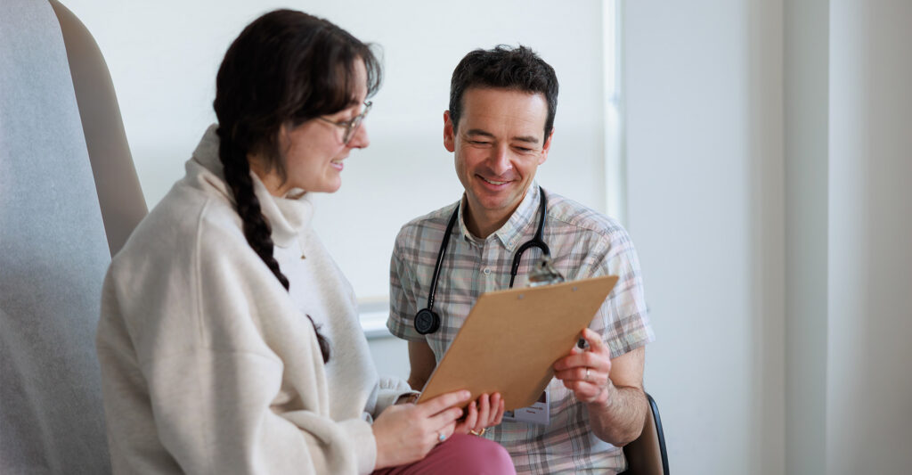 Provider and patient looking at a clipboard