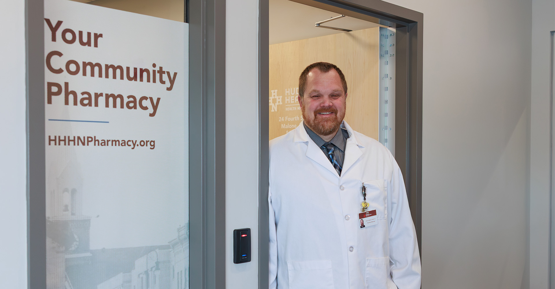 Pharmacist standing in the entryway of Pharmacy at Malone