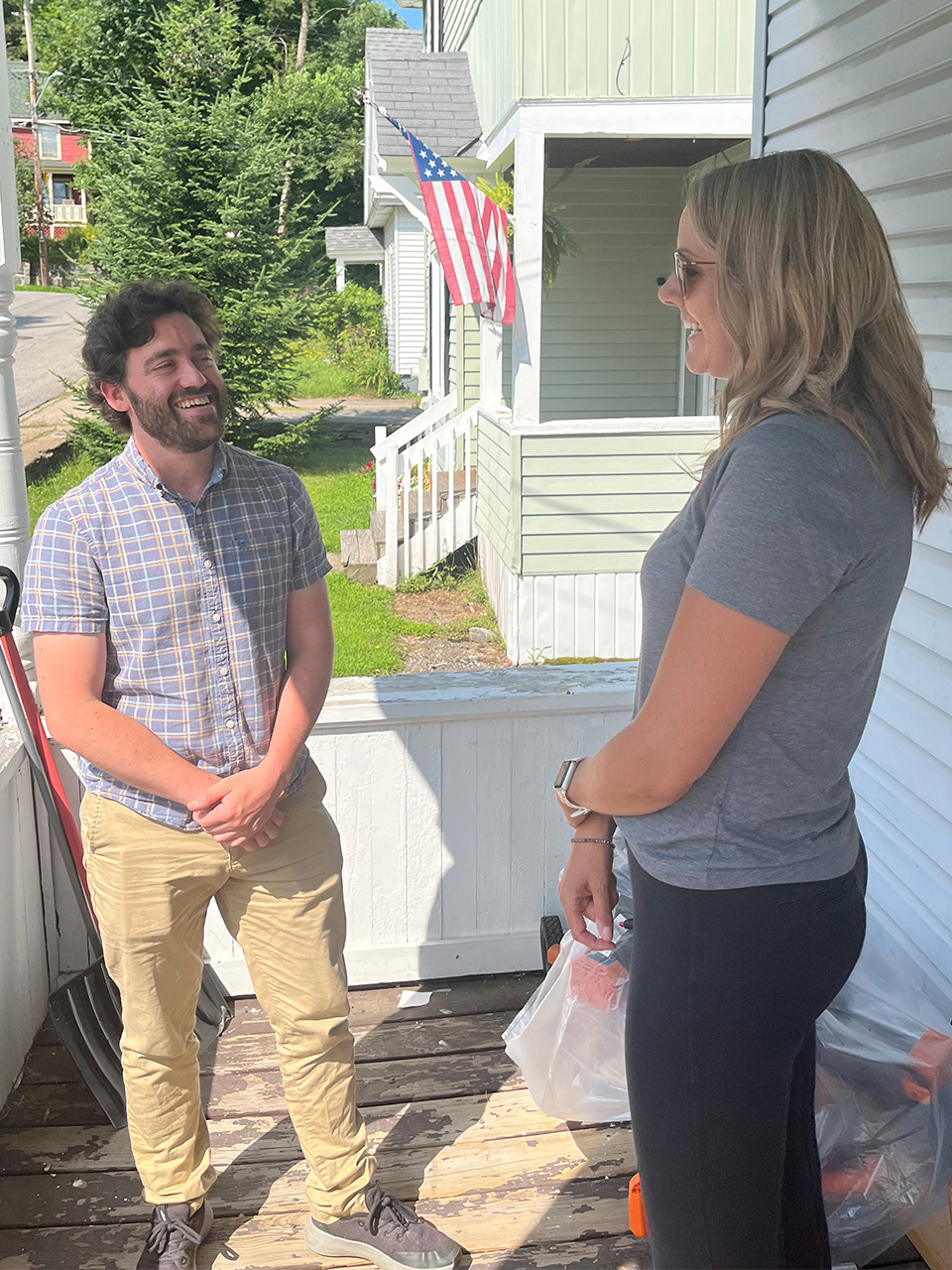 Representatives from Beacon House and Hudson Headwaters talking on a porch